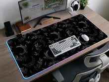 Black mousepad with a lunar pattern featuring crescent moons, small star clusters, and delicate botanical details.