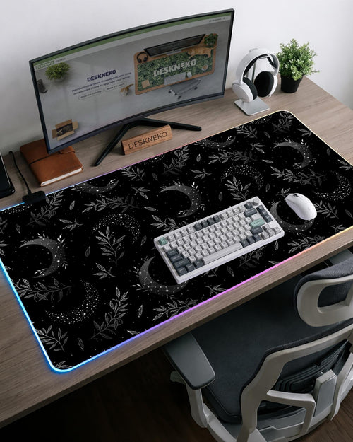 Black mousepad with a lunar pattern featuring crescent moons, small star clusters, and delicate botanical details.