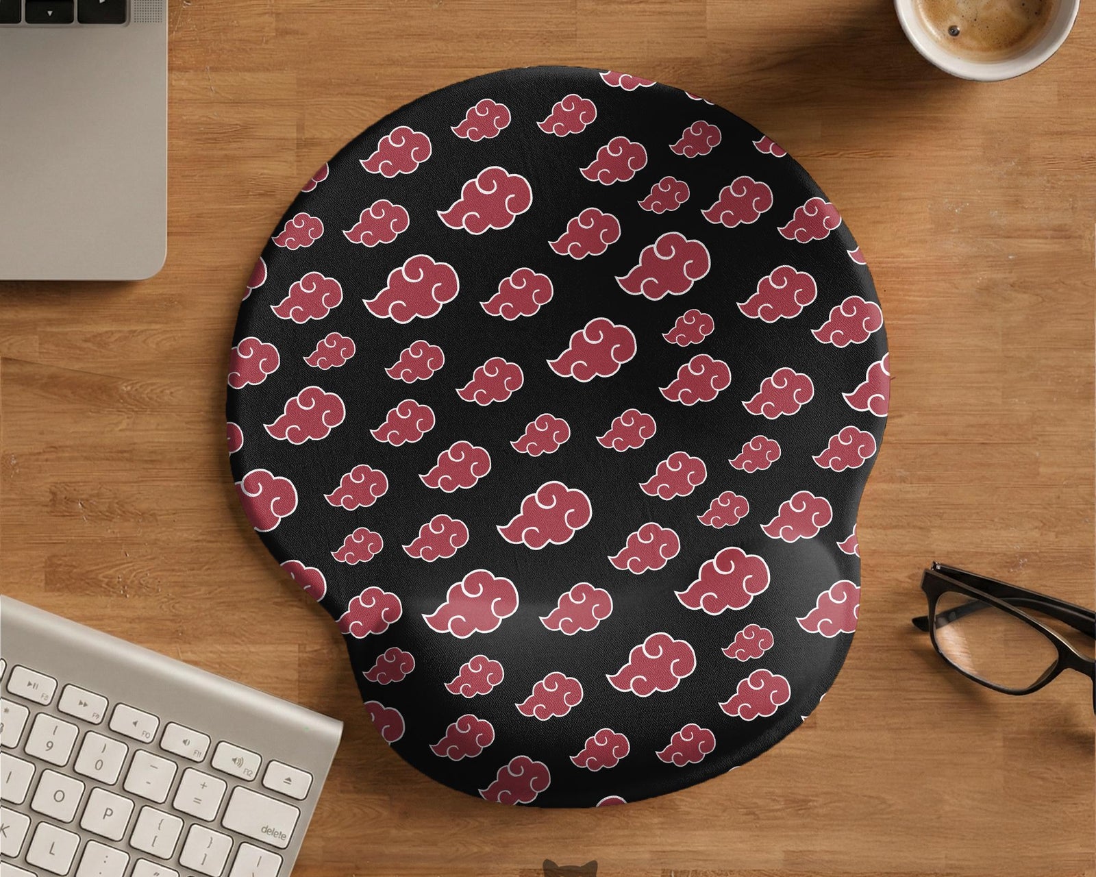 Black mouse pad with a red cloud pattern and matching keyboard wrist rest option shown as desk accessories.