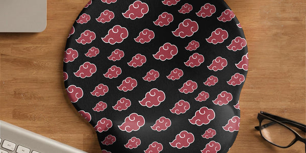 Black mouse pad with a red cloud pattern and matching keyboard wrist rest option shown as desk accessories.