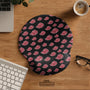 Black mouse pad with a red cloud pattern and matching keyboard wrist rest option shown as desk accessories.