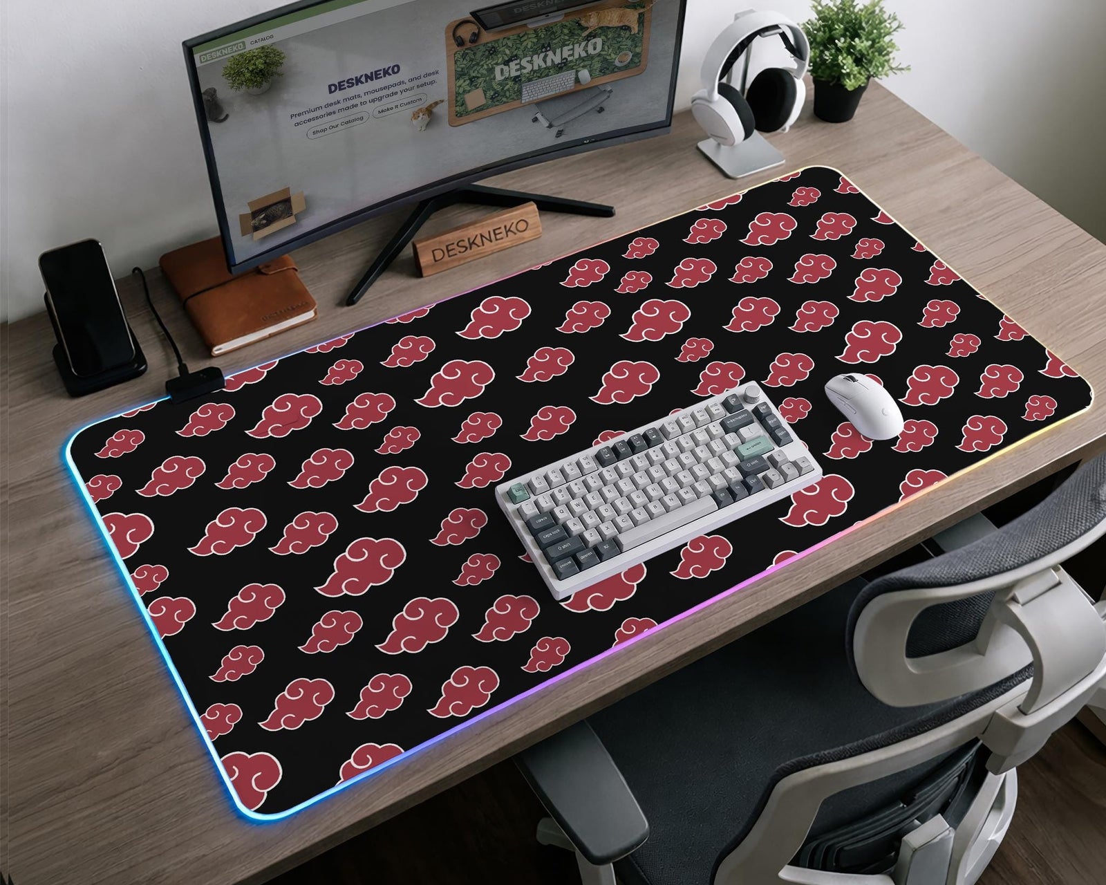 Black desk mat with a red cloud pattern and RGB LED lighting around the edges.