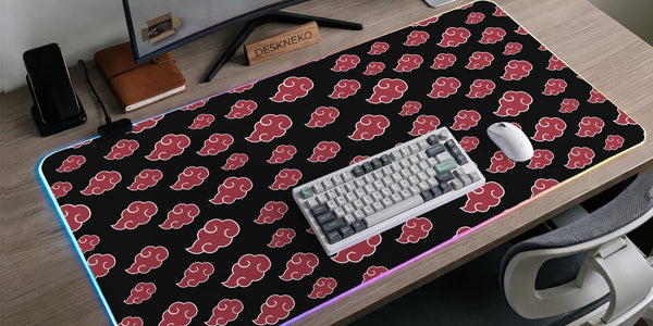Black desk mat with a red cloud pattern and RGB LED lighting around the edges.