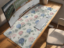 Floral desk mat with sage greenery, pink peonies, blue flowers, and a warm cream background.