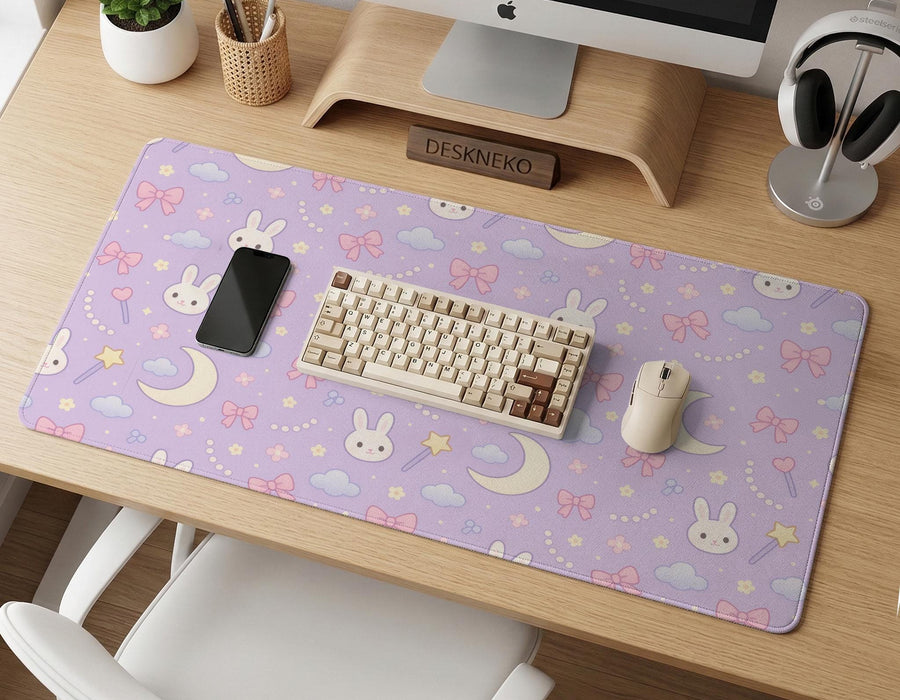 Pastel lavender desk mat with an all-over pattern of bunnies, crescent moons, clouds, bows, stars, and small flowers.