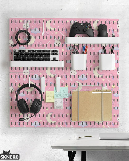 Pink pegboard panels with bunny, moon, cloud, bow, star, and small flower designs, shown as a wall organizer set with containers, shelves, clips, hooks, and a letter holder.