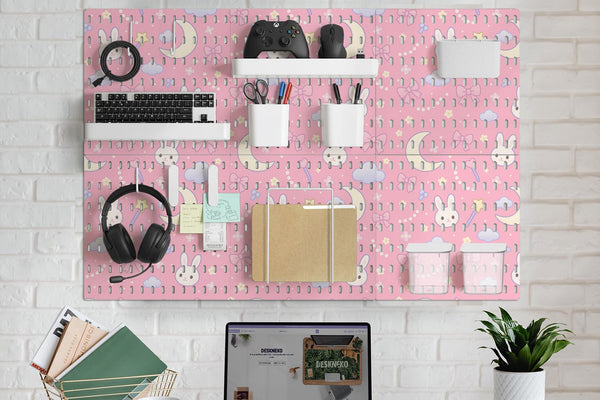 Pink pegboard panels with a kawaii bunny, cloud, moon, bow, and star pattern shown as a wall organizer set.