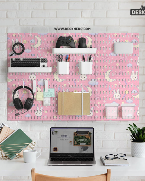 Pink pegboard panels with a kawaii bunny, cloud, moon, bow, and star pattern shown as a wall organizer set.