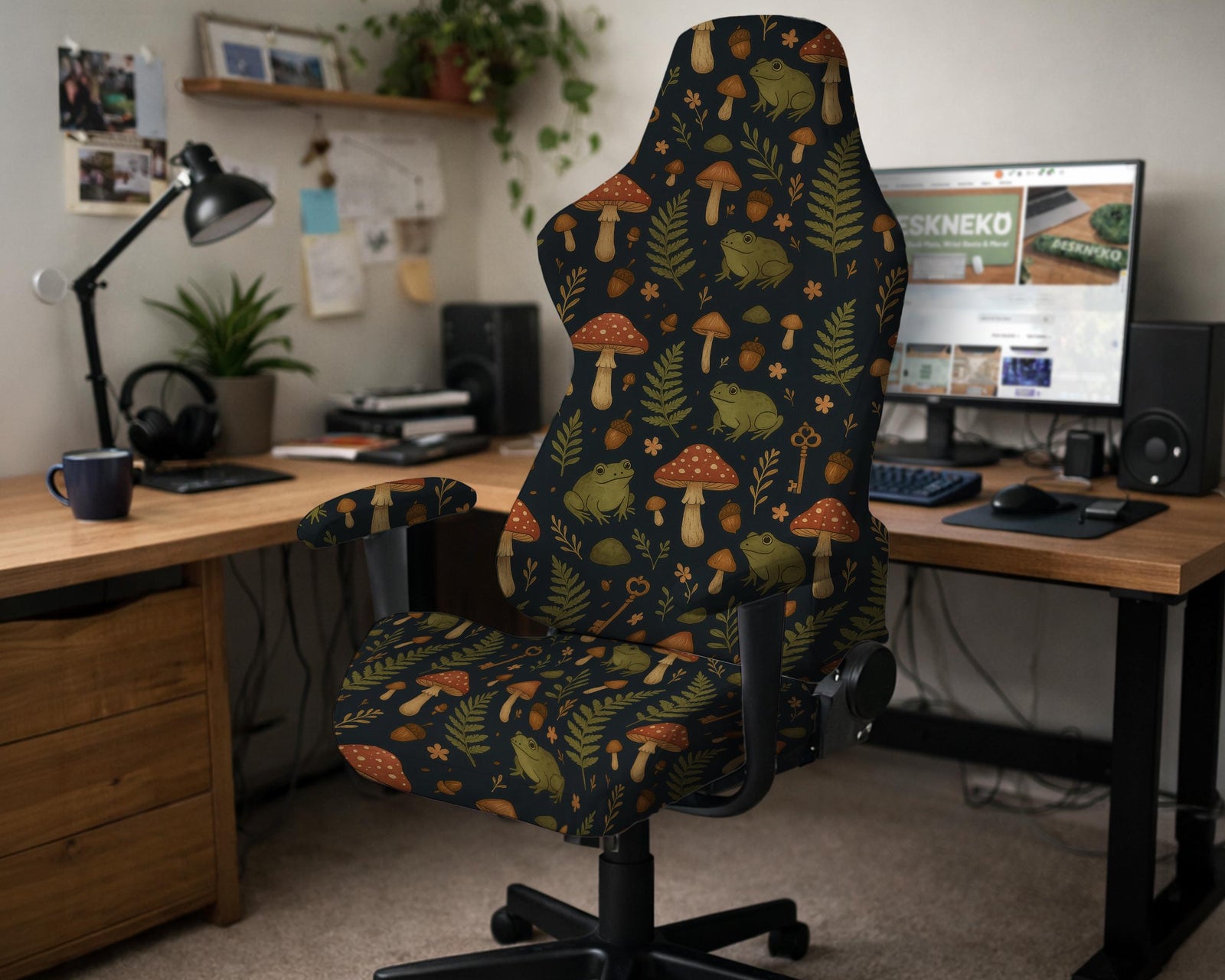 A gaming chair cover with a dark woodland pattern showing frogs, mushrooms, and ferns in earthy green and brown tones.