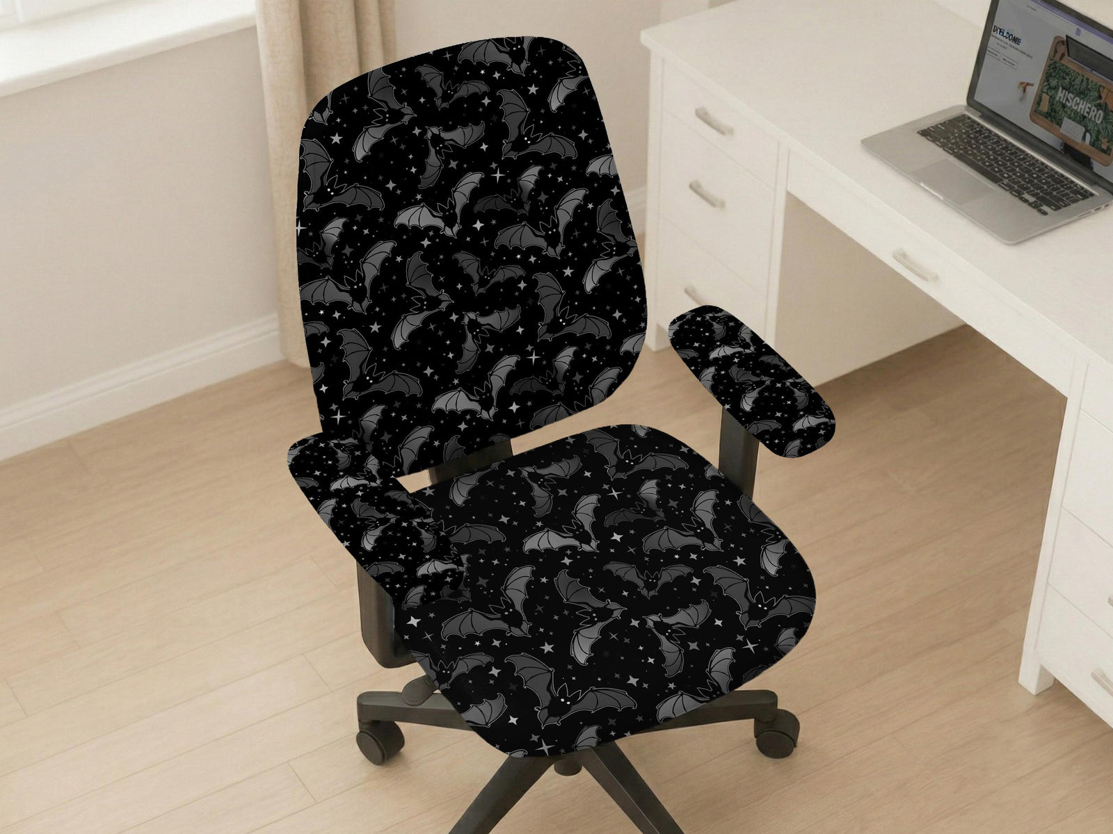 Black and gray chair cover with a bat and star print shown on an office chair.