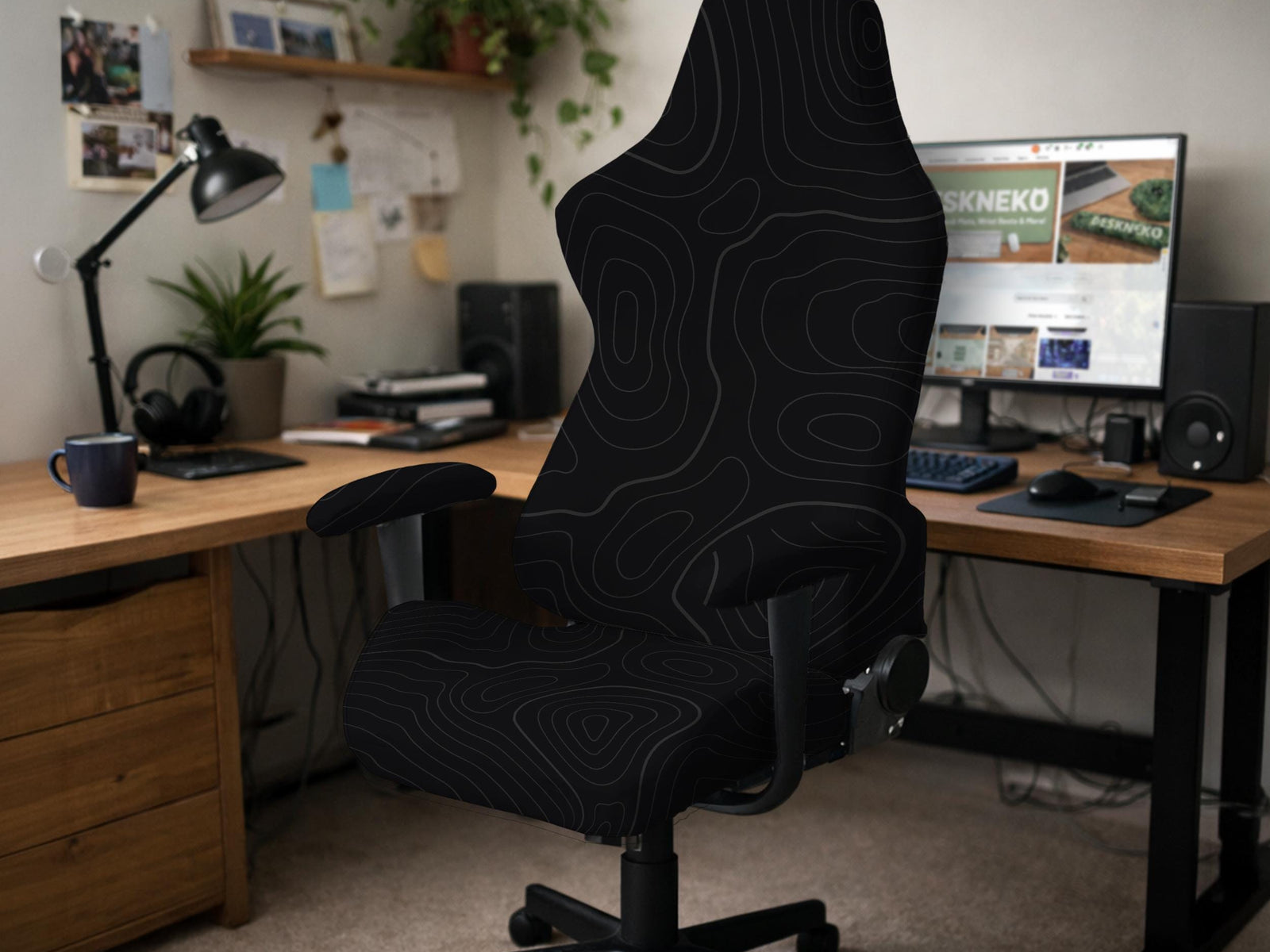 Black chair cover with a thin line art pattern on a gaming chair, shown with a high back and armrest areas covered.