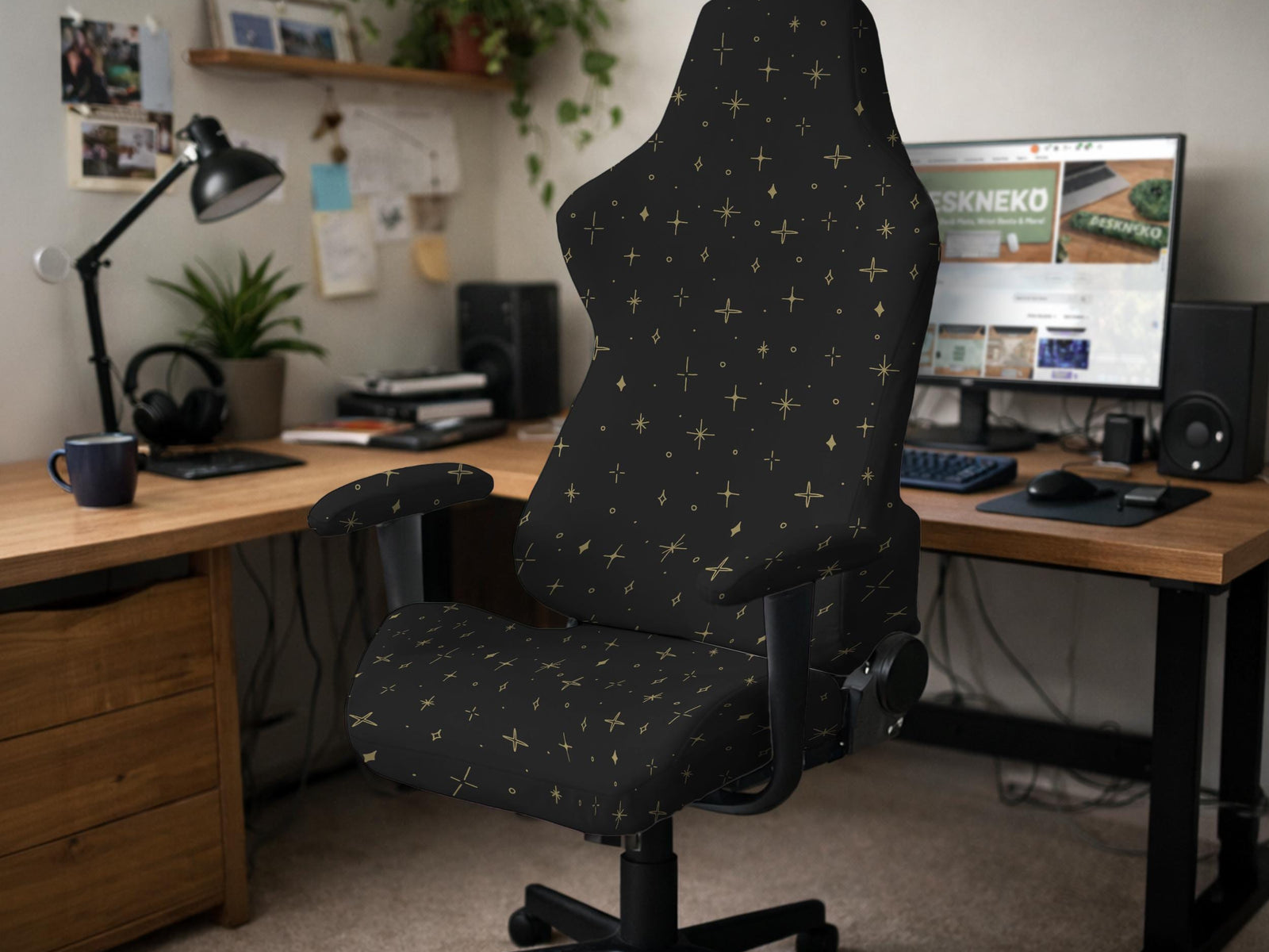 Black stretch chair cover with small gold star pattern, shown on a high-back chair with armrests.