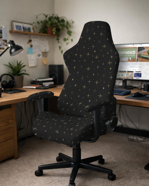 Black stretch chair cover with small gold star pattern, shown on a high-back chair with armrests.