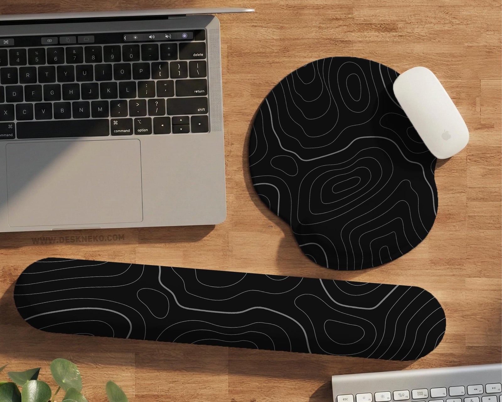 Black mousepad with a gray topographic contour line pattern shown with matching keyboard wrist rest options.