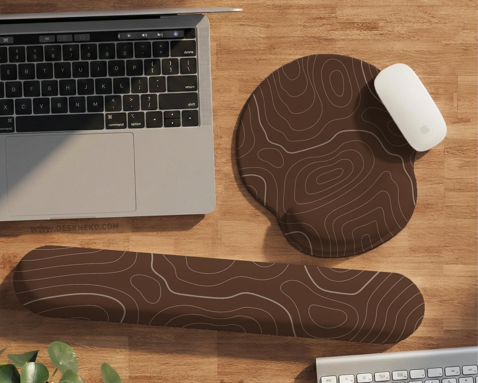 Brown mousepad and keyboard wrist rest with a topographic contour-line pattern.