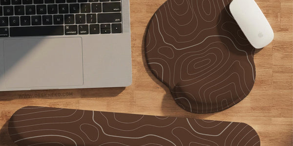 Brown mousepad and keyboard wrist rest with a topographic contour-line pattern.
