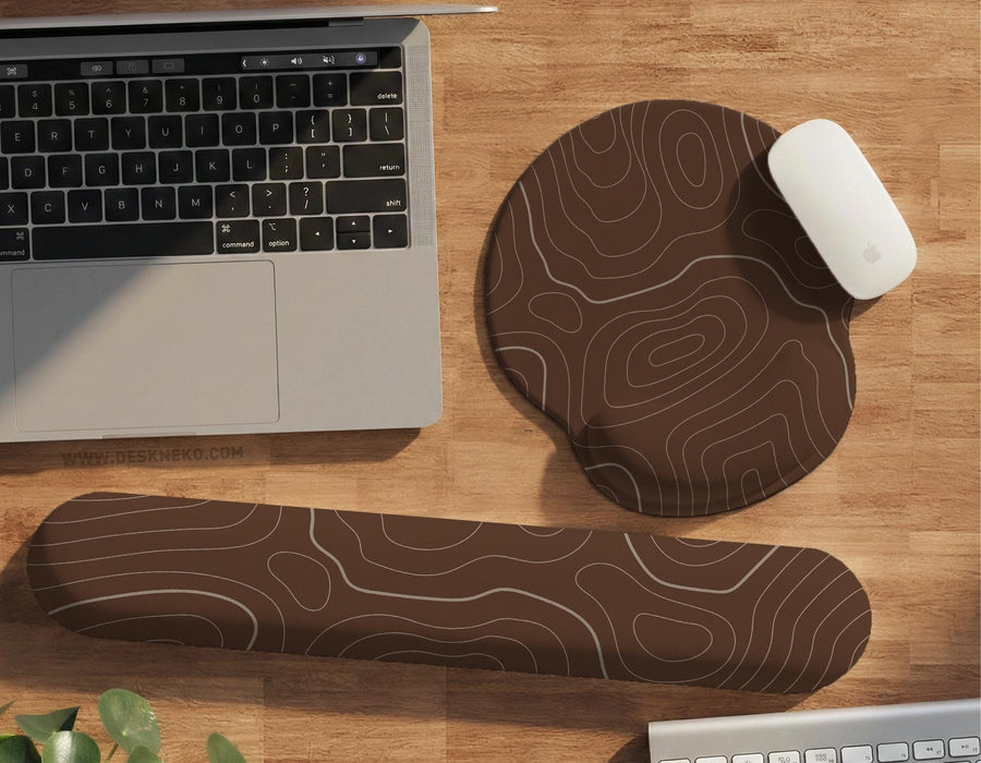 Brown mousepad and keyboard wrist rest with a topographic contour-line pattern.