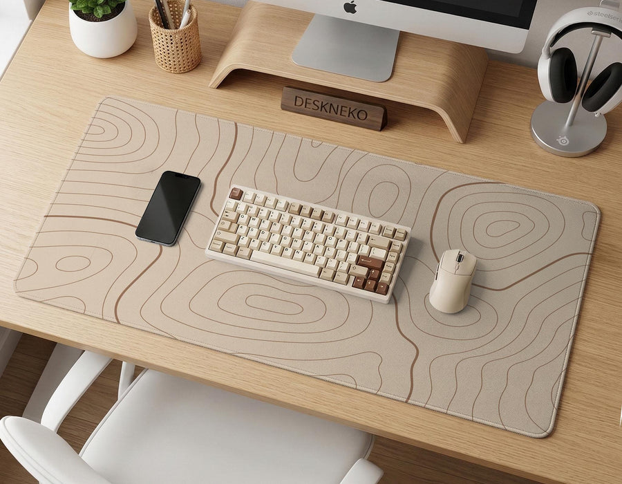 Beige desk mat with soft brown topographic contour lines on a neutral background.