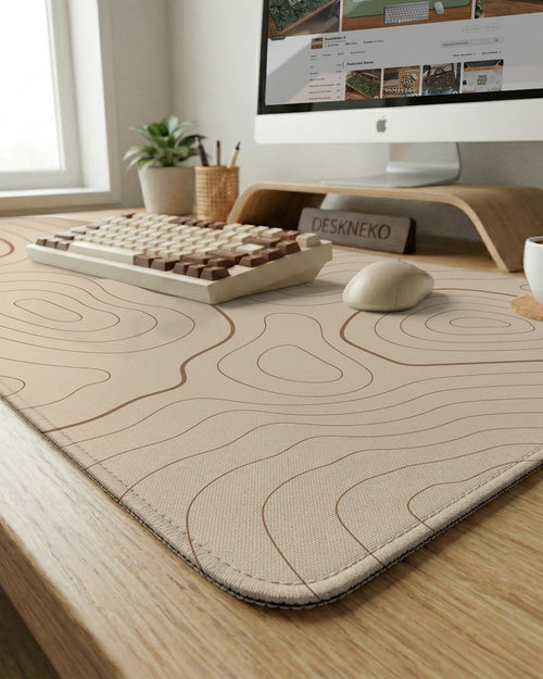 A beige mousepad with a topographic line pattern in a repeating design.