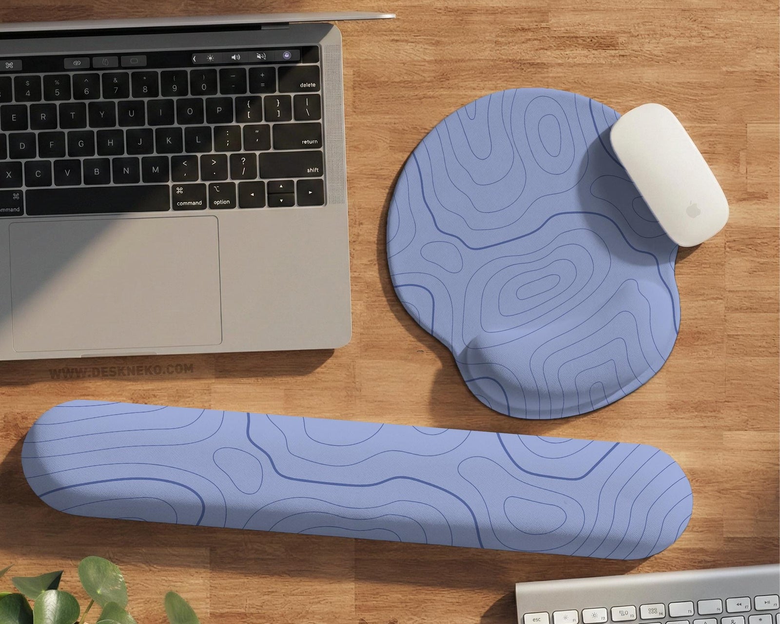 Periwinkle desk mat with a topographic contour line pattern in light blue and white.