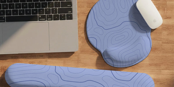 Periwinkle desk mat with a topographic contour line pattern in light blue and white.