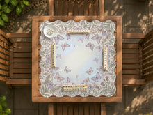 Square mahjong mat with a scalloped edge, floral and butterfly artwork in pale blue, cream, lavender, blush pink, and sage green, and a lighter center area.