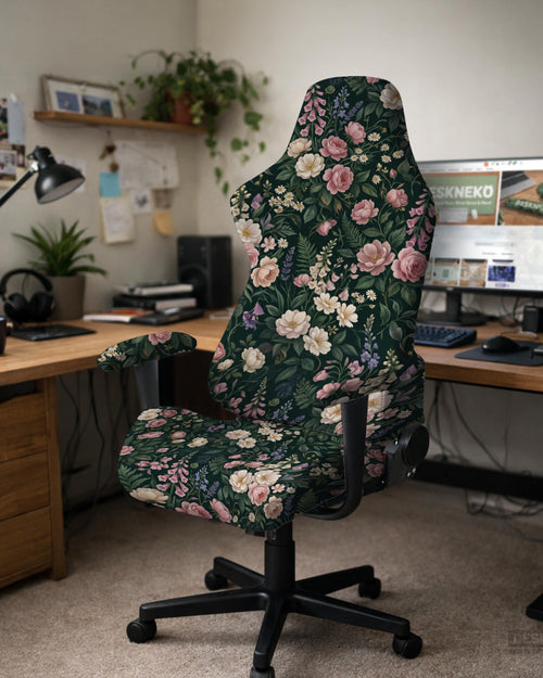 Dark botanical floral print chair cover shown on a black high back gaming chair with armrests.