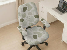 Green desk chair cover with an abstract leaf pattern in soft neutral tones.