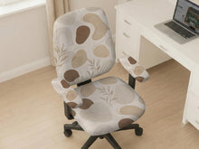 Beige chair cover with abstract organic shapes, small botanical details, and thin linework on a light neutral background.