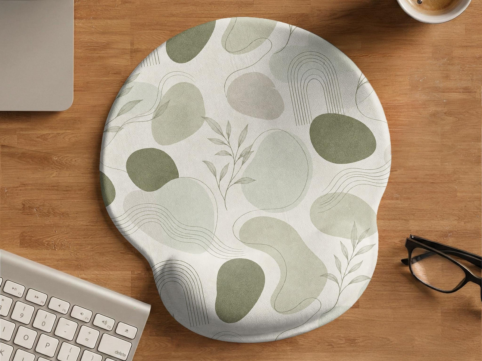 Green abstract botanical mouse pad with a rounded organic pattern and matching keyboard wrist rest option.