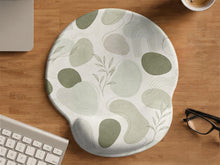 Green abstract botanical mouse pad with a rounded organic pattern and matching keyboard wrist rest option.