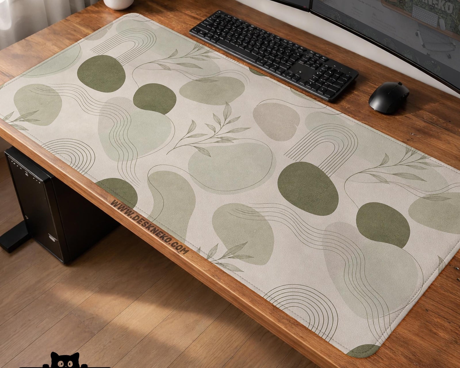 Green desk mat with an abstract botanical pattern in sage and darker green tones.