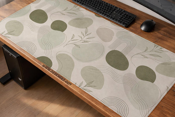 Green desk mat with an abstract botanical pattern in sage and darker green tones.
