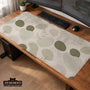 Green desk mat with an abstract botanical pattern in sage and darker green tones.