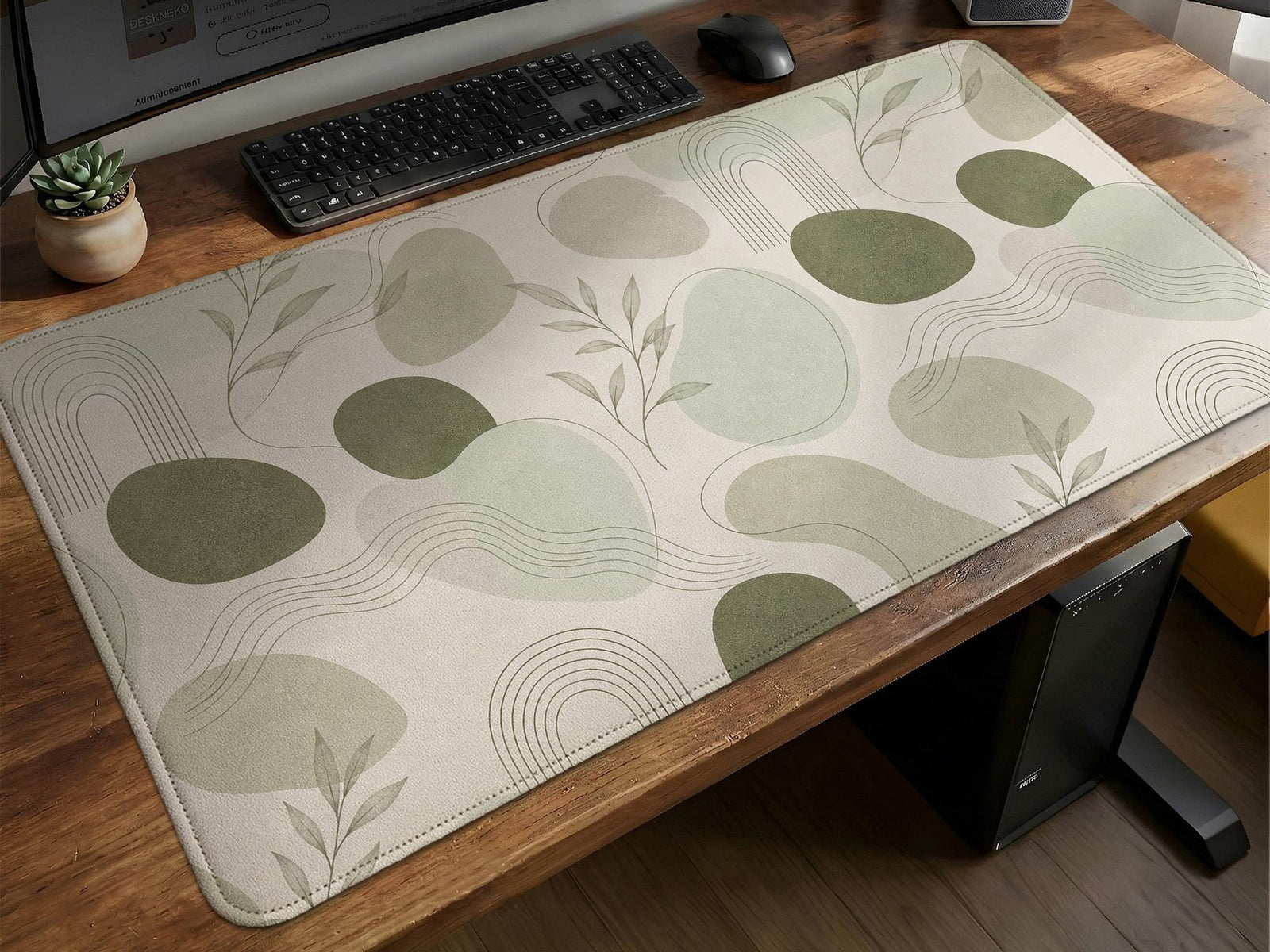 Sage green desk mat with a botanical leaf pattern in a minimal style.