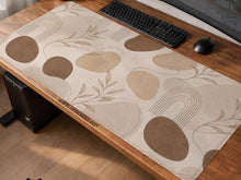 Beige desk mat with fine botanical line drawings and soft abstract shapes on a light neutral background.