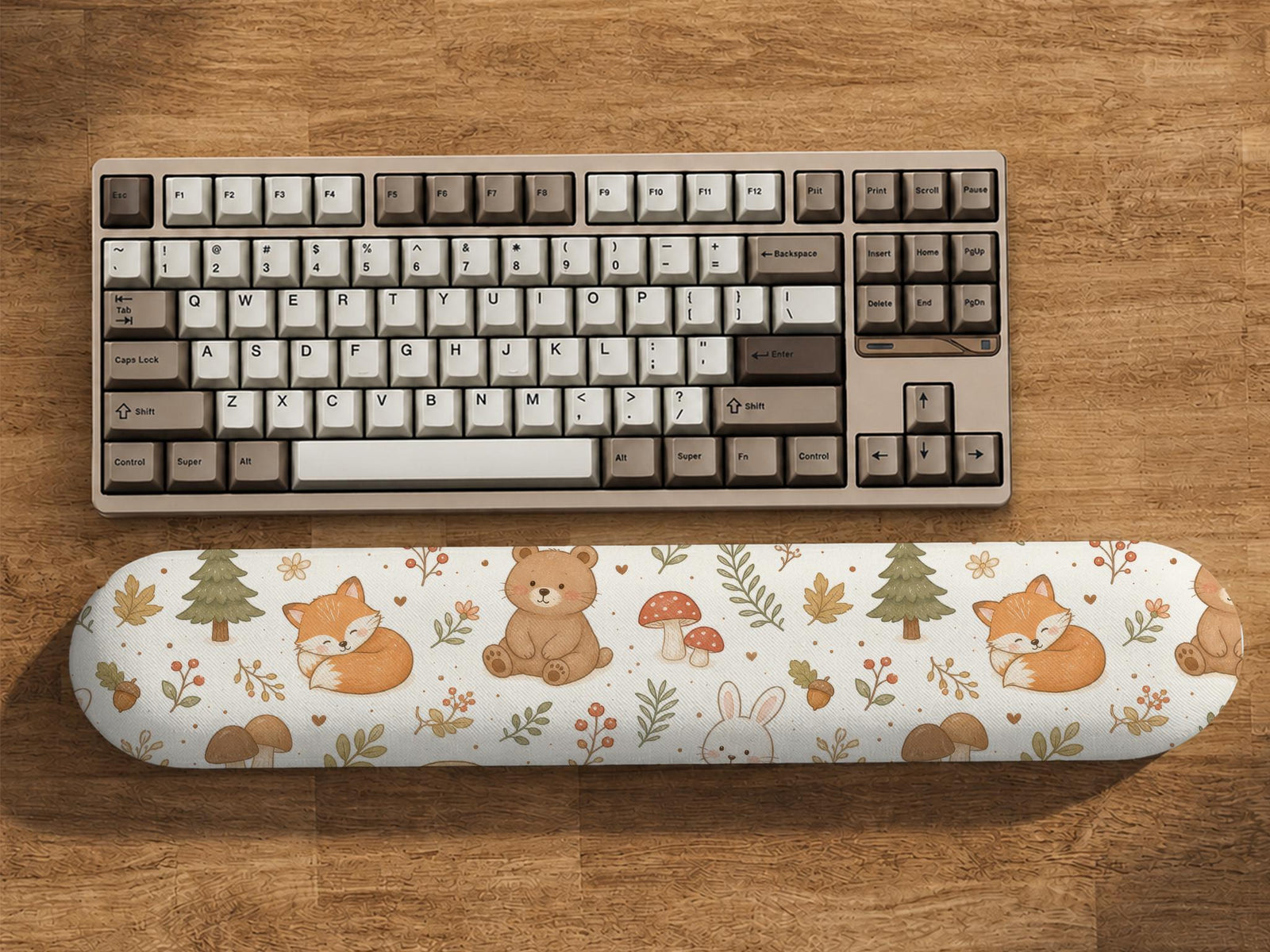 Cream mouse pad and keyboard wrist rest with a woodland pattern featuring foxes, bunnies, bears, mushrooms, acorns, and leaves.