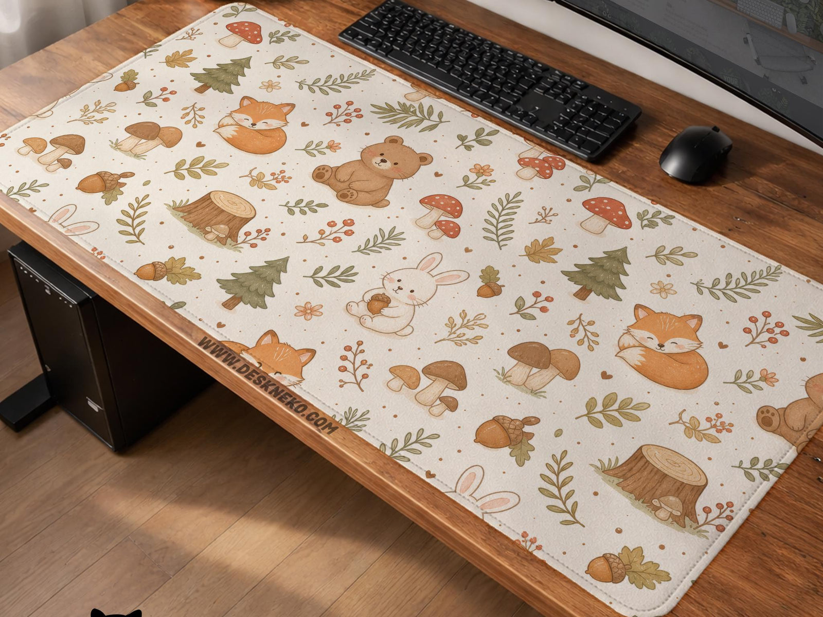 Cream desk mat with a woodland animal pattern featuring foxes, bunnies, mushrooms, berries, acorns, and sage leaves in soft green tones.