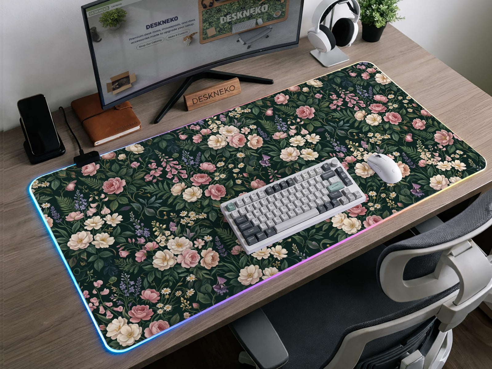 Dark green desk mat with pink roses, ivory flowers, lavender stems, and layered botanical foliage.