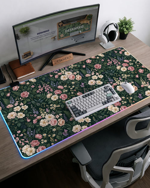 Dark green desk mat with pink roses, ivory flowers, lavender stems, and layered botanical foliage.