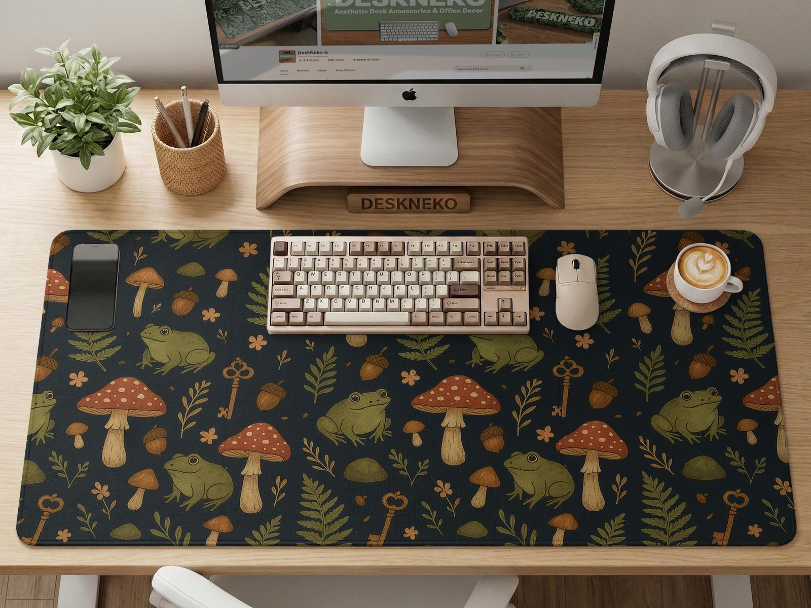 Dark forest-themed desk mat with an all-over pattern of frogs, mushrooms, fern leaves, acorns, tiny flowers, and antique keys.