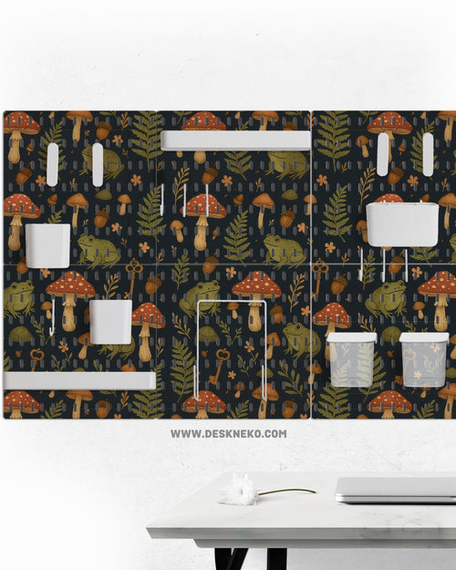Six pegboard panels with a dark woodland frog and mushroom design, plus hooks, shelves, containers, clips, and a folder holder.