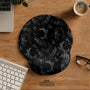 Black mouse pad and wrist rest with moon phases, small stars, and fine botanical accents in a dark floral pattern.