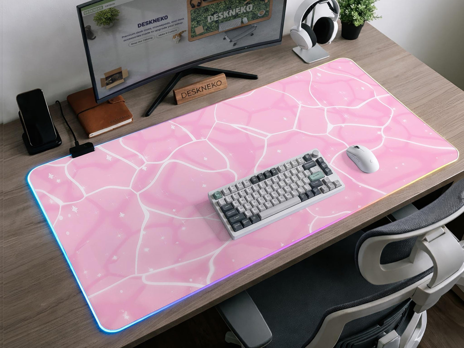 Pastel pink desk mat with a marble-style design, white flowing lines, and small sparkle accents.