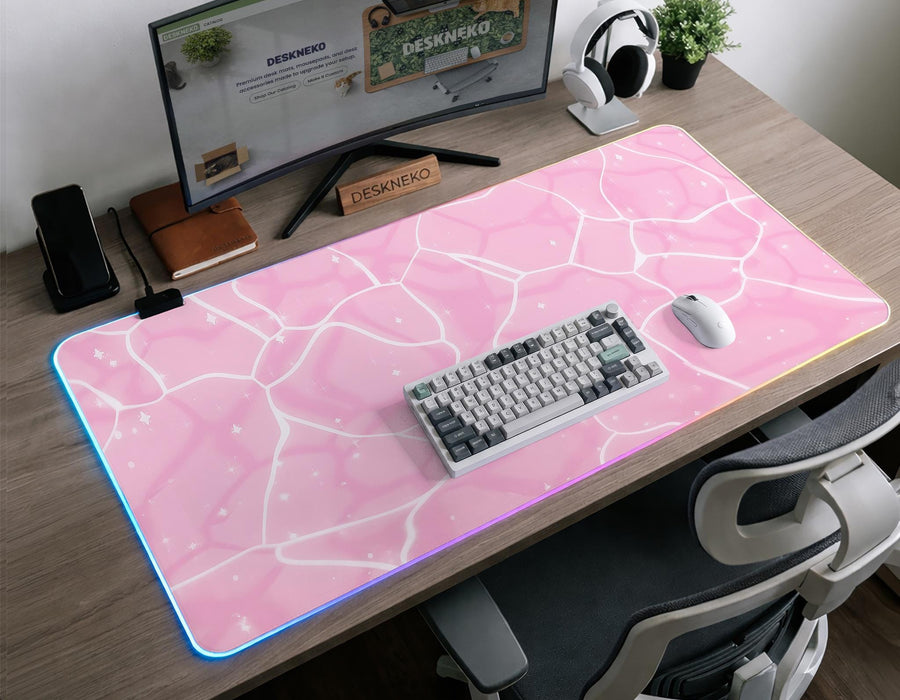 Pastel pink desk mat with a marble-style design, white flowing lines, and small sparkle accents.
