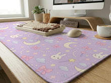 Lavender desk mat with a bunny pattern, moons, stars, clouds, and bows in a pastel style.