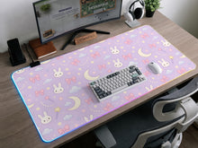Lavender desk mat with a repeating bunny, moon, cloud, and bow pattern in pastel colors.