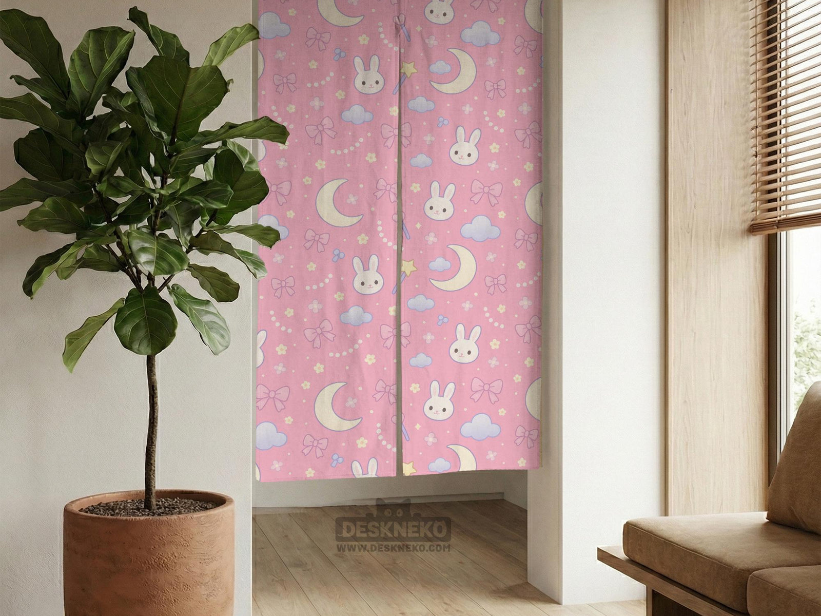 Pink noren curtain with cute bunny faces, crescent moons, blue clouds, bows, stars, and small flowers on a warm pink background.