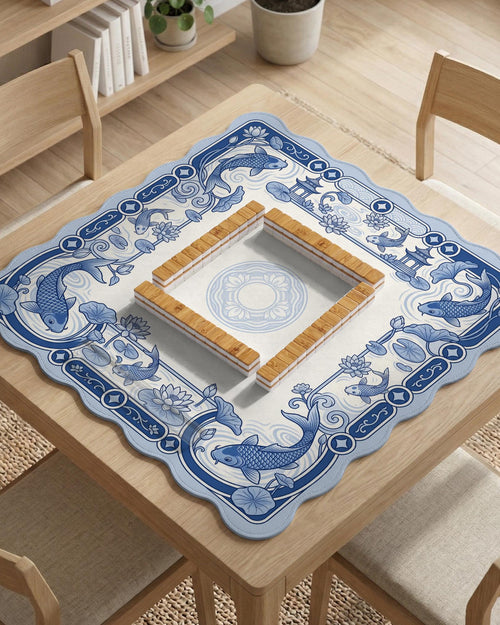 Navy blue square mahjong table mat with lotus flowers and koi fish in a porcelain-style border and a plain center.