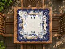 Blue mahjong table mat with a peacock and floral border, ivory center, lavender flowers, and scalloped edges.